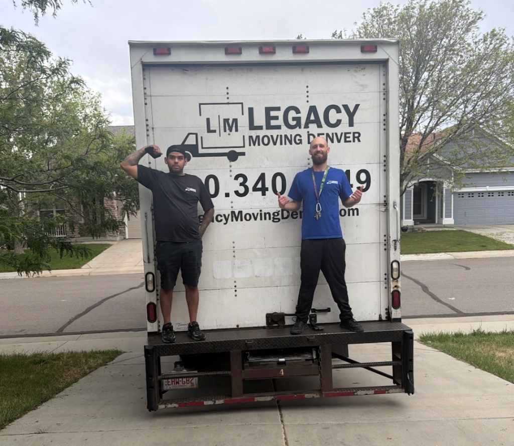 Legacy Moving Denver two movers on truck lift